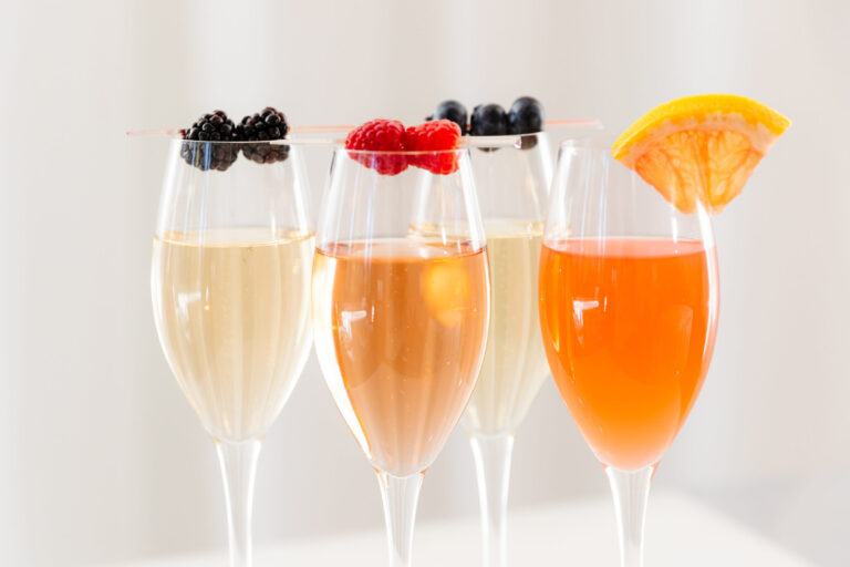 Elegant champagne cocktails garnished with fresh berries and citrus served during cocktail hour at Lakeview Pavilion in Foxborough, Massachusetts.