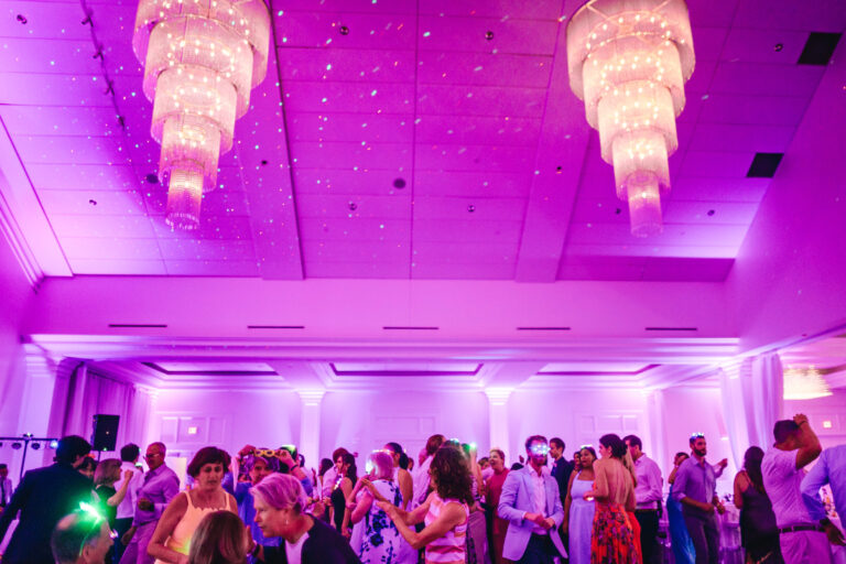 Guests dancing during a lively wedding reception in the Lakeview Ballroom at Lakeview Pavilion in Foxborough, Massachusetts.