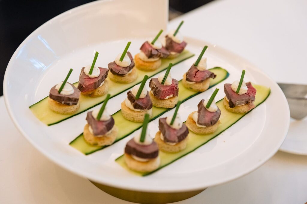 Beef tenderloin medallion crostini topped with garlic Boursin mousse and fresh chives served as a passed hors d'oeuvre at Lakeview Pavilion in Foxborough, Massachusetts.