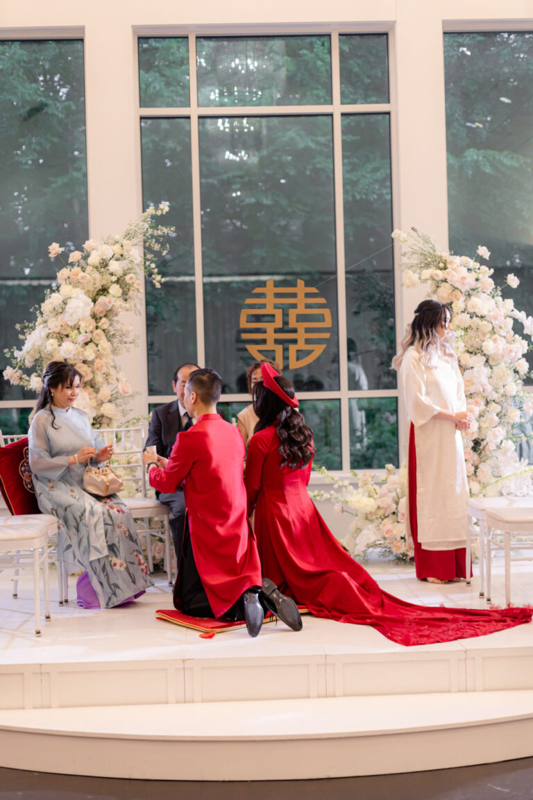 Couple participating in a meaningful wedding ceremony tradition with family in the Lakeview Ballroom at Lakeview Pavilion in Foxborough, Massachusetts.