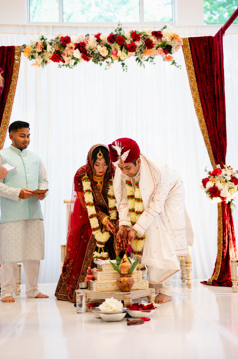Couple participating in a meaningful wedding ceremony tradition in the Lakeview Ballroom at Lakeview Pavilion in Foxborough, Massachusetts.
