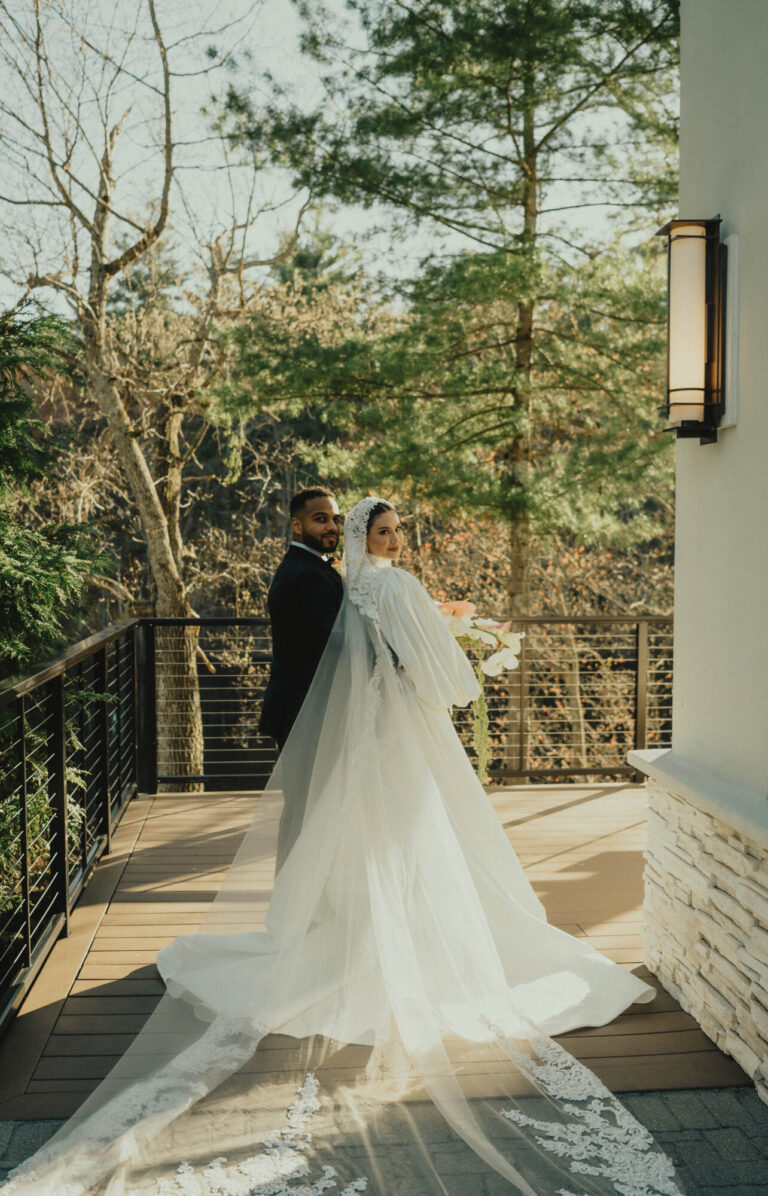 Bride and groom sharing a quiet moment on the outdoor terrace overlooking the trees at Lakeview Pavilion in Foxborough, Massachusetts.