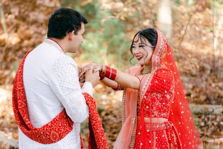 Couple sharing a joyful first look during their wedding celebration at Lakeview Pavilion in Foxborough, Massachusetts, surrounded by beautiful natural scenery.