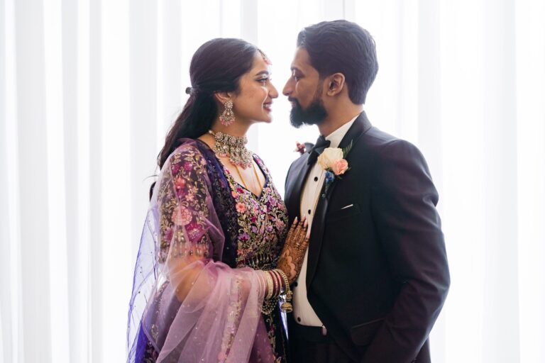 Newlywed couple sharing a romantic portrait inside the Lakeview Ballroom at Lakeview Pavilion in Foxborough, Massachusetts, surrounded by natural light and elegant wedding décor.