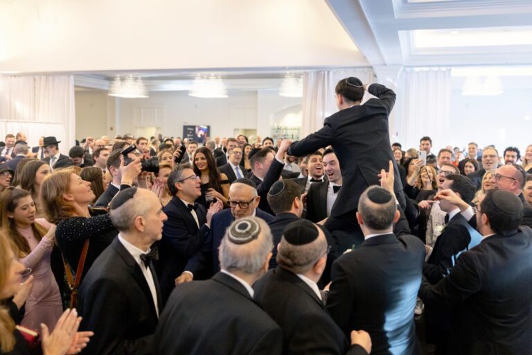 Guests lifting the groom during the Hora celebration in the Lakeview Ballroom at Lakeview Pavilion in Foxborough, Massachusetts.