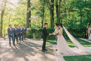 Bride and groom greeting family during an outdoor wedding ceremony at Lakeview Pavilion in Foxborough, Massachusetts.
