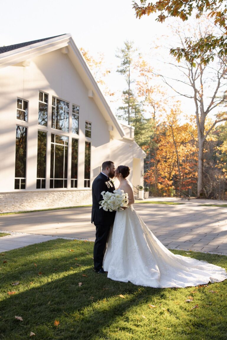 Bride and groom celebrating a fall wedding outside Lakeview Pavilion's modern waterfront wedding venue in Foxborough, Massachusetts.