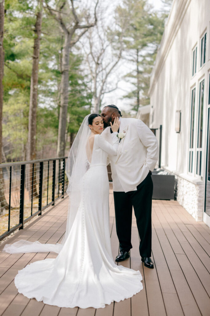 Bride and groom sharing a romantic wedding portrait on the private terrace outside the Lakeside Ballroom at Lakeview Pavilion in Foxborough, Massachusetts.